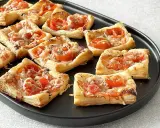 Pizzerinki z ciasta francuskiego z pomidorkami i serem. Idealne na szybką przekąskę.
