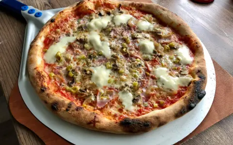 Idealna pizza na kamieniu, z chrupiącym ciastem i pysznymi dodatkami. Tak piecze się pizzę na kamieniu!