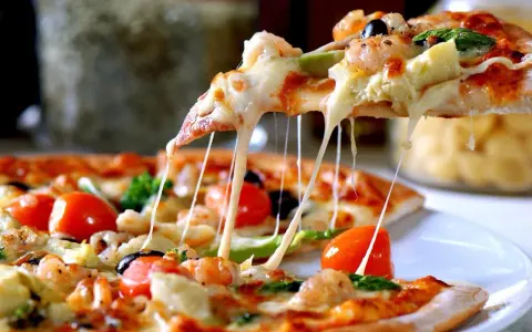 Rozciągający się ser z pizzy z krewetkami i pomidorkami. Idealna na kolację, nawet jeśli ciasto na pizzę przygotowano dzień wcześniej.
