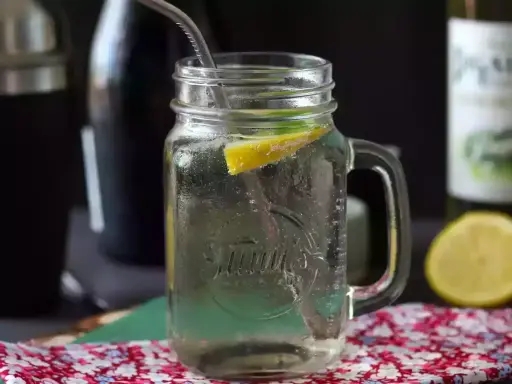 Orzeźwiający Hugo Spritz w słoiku z cytryną i miętą, gotowy do wypicia.