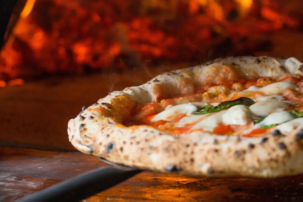Gorąca pizza prosto z pieca, przypominająca o tym, skąd pochodzi pizza – z Neapolu.