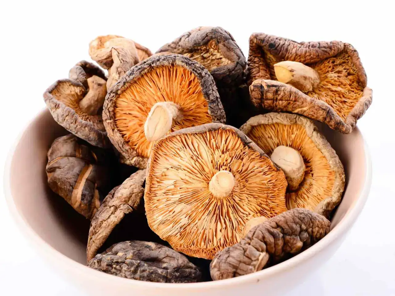 Suszone grzyby shiitake w misce. Zastanawiasz się, jak długo gotować grzyby, aby były idealne?